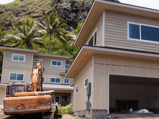 A heavy machinery near a cream colored house