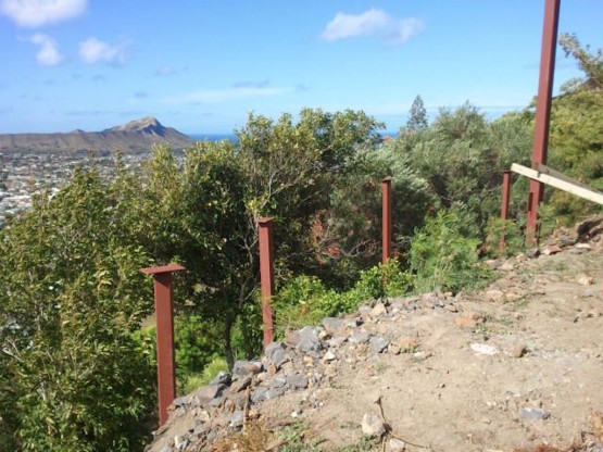 Red colored Metal railings near the slope