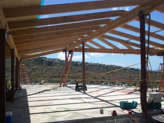 A long wooden house under construction