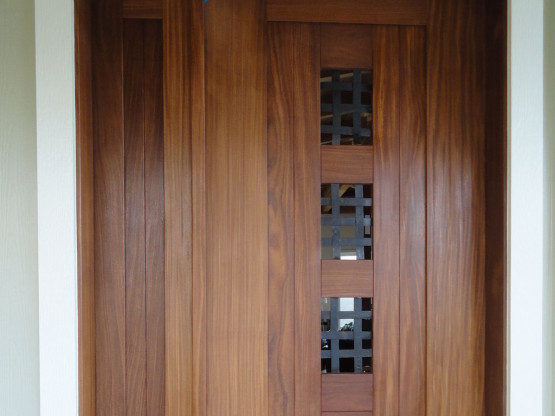 Brown colored door with spaces in between