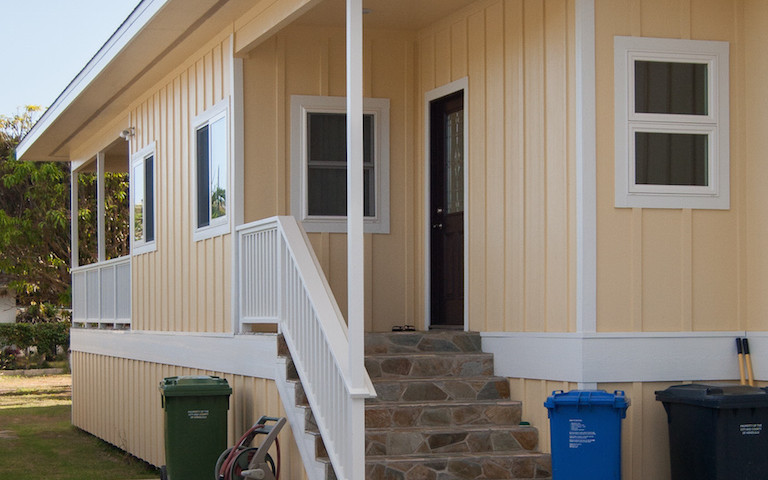 Steps leading inside the cream colored house