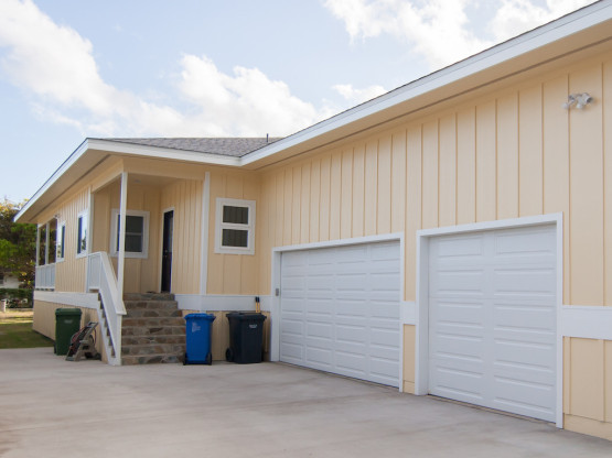 Two garage door in a cream colored house