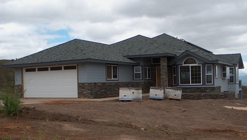 A grey colored house with a dark grey roof