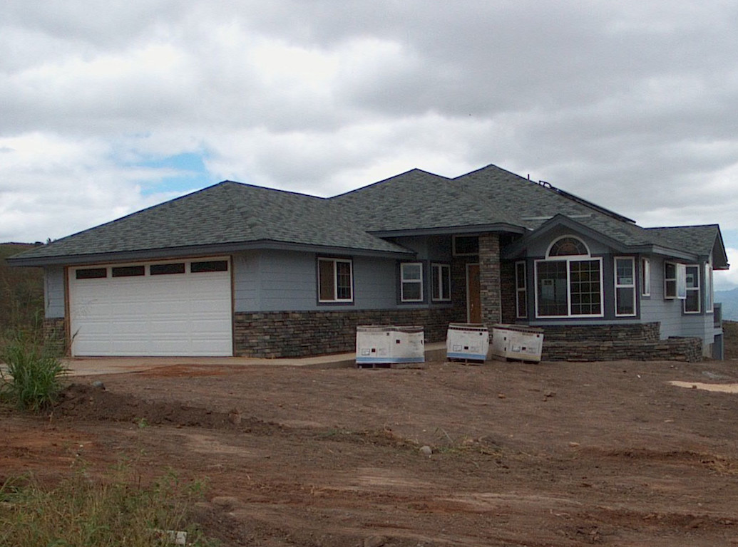 A grey colored house with a dark grey roof