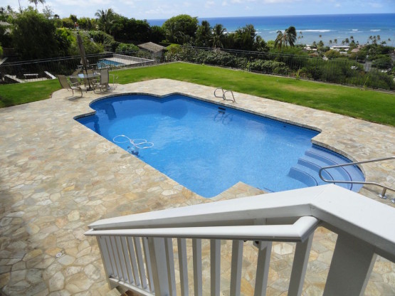 A swimming pool with steps and railings