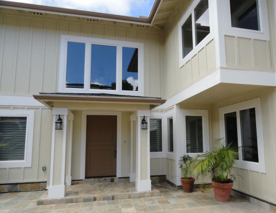 Entrance of a white colored house with roof