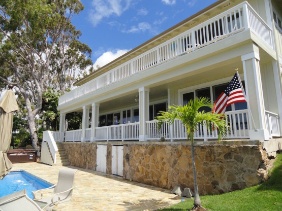 A country flag on a white colored house