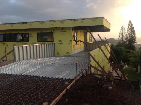 A yellow house with pathway under construction
