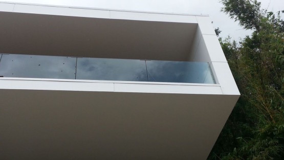 White colored balcony with glass corners