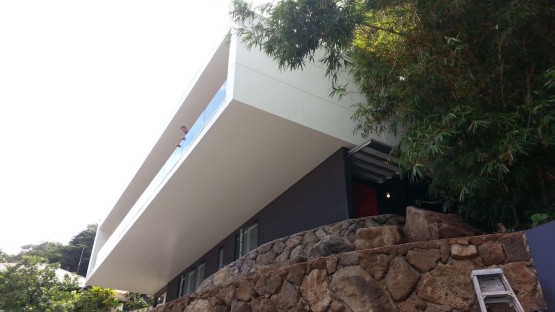 A man standing in the balcony of a house