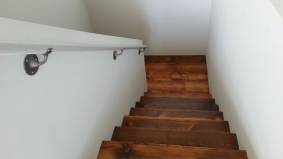 Brown colored staircase with metal railings