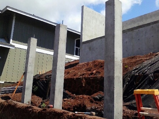 Three cement pillars in an under construction site