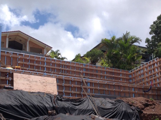 Black covers near a wooden frame used for construction