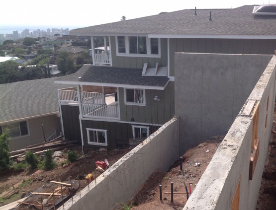 A grey colored house by the hillside