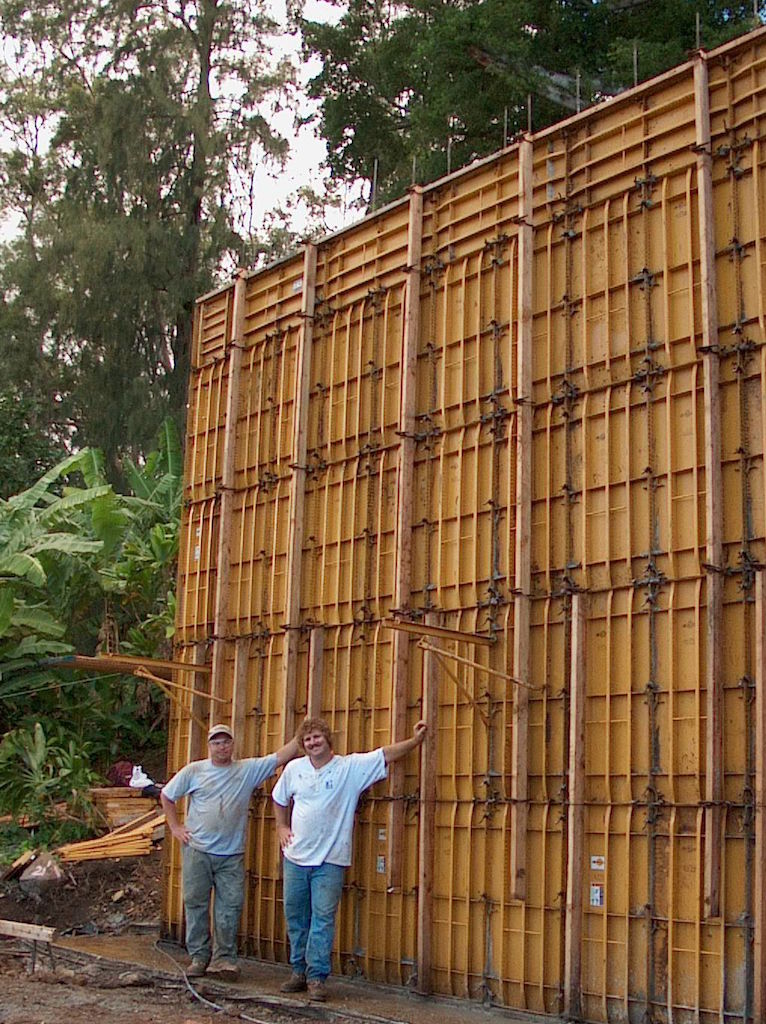 Two people posing near a metal board