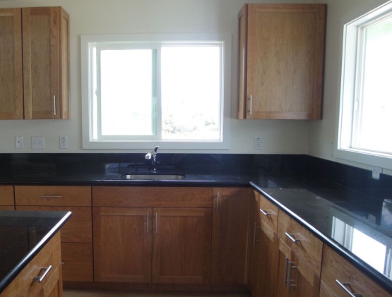 Wooden cabinets and black colored table top