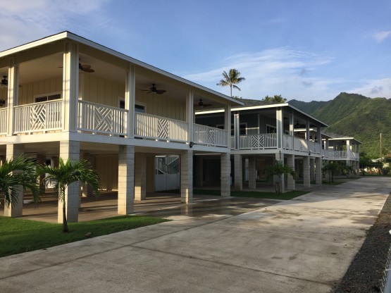 Three similar white colored houses in order