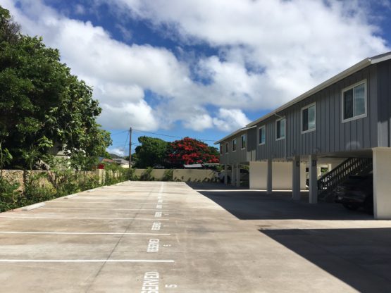 A grey colored Hale Maluniu duplex building